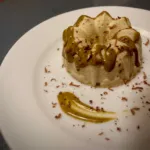 Sweet pudding with pistachio sauce and chocolate chips