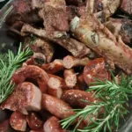 Mixed grilled meat with sausages and fresh rosemary, barbecue catering