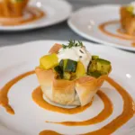 Filo pastry basket with vegetables, yogurt cream and spicy tomato sauce