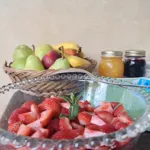 Breakfast table with fresh fruit, jams and strawberries for the event