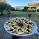 Mixed fresh fruit platter served in the garden overlooking the Tuscan hills