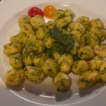 Pesto gnocchi with red and yellow cherry tomatoes, catering dish