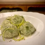 Ricotta and spinach gnudi seasoned with lemon zest