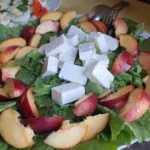 Salad with fresh peaches and feta cubes, summer menu