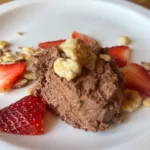 Chocolate mousse cup with fresh strawberries and chopped walnuts