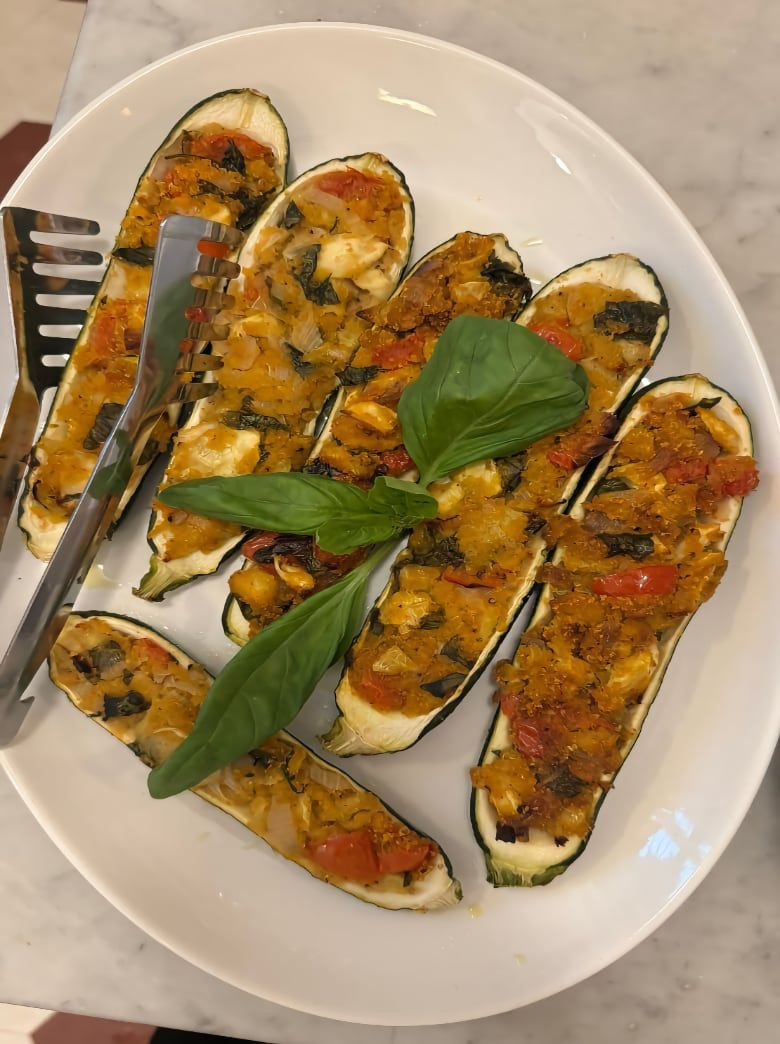 Basil-topped stuffed zucchini boats prepared during the vegetarian, vegan and gluten-free cooking class